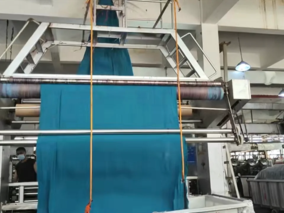 Teal wide fabric running continuously at Yuxin factory